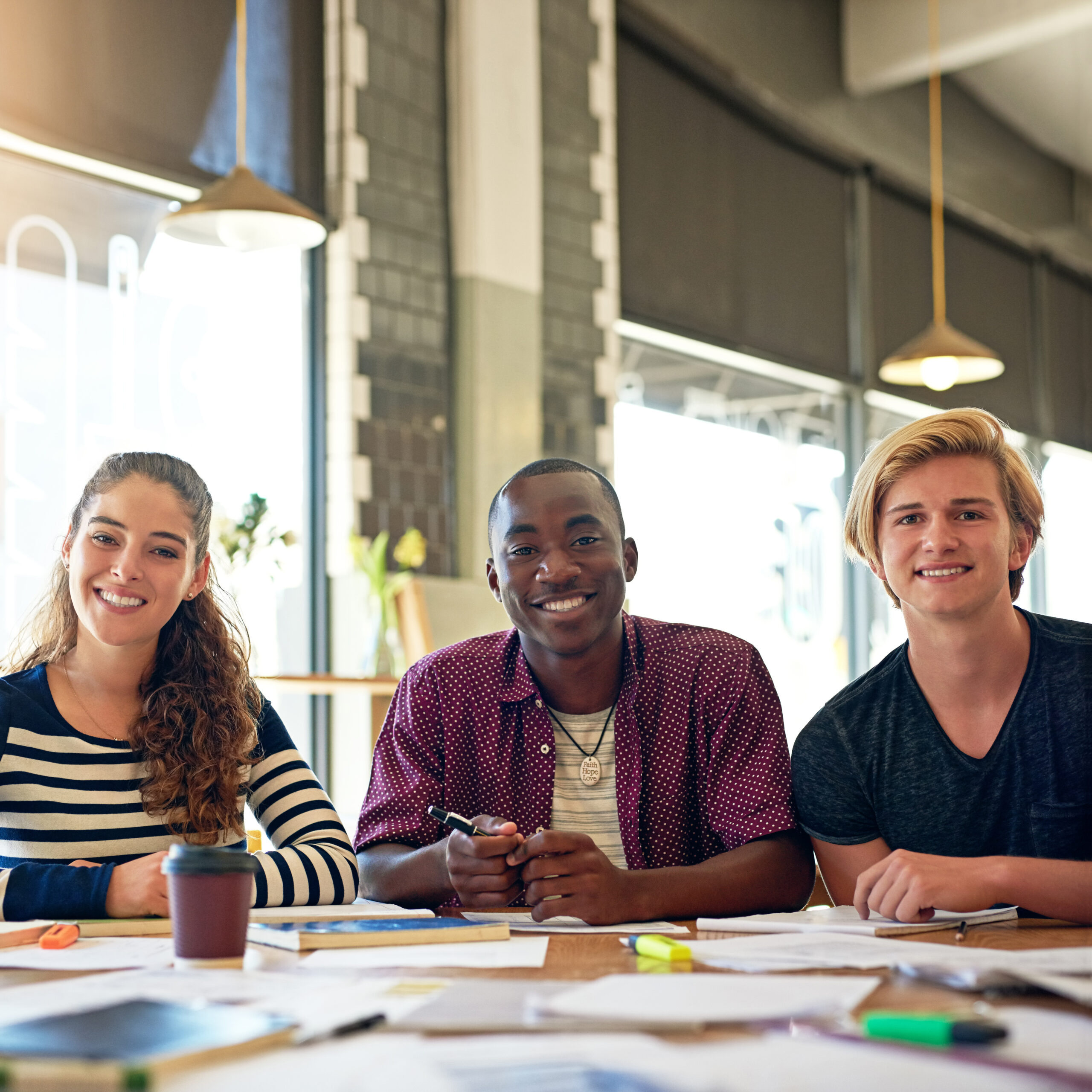 Welcome to our study spot. Portrait of a group of happy students having a study session in a cafe